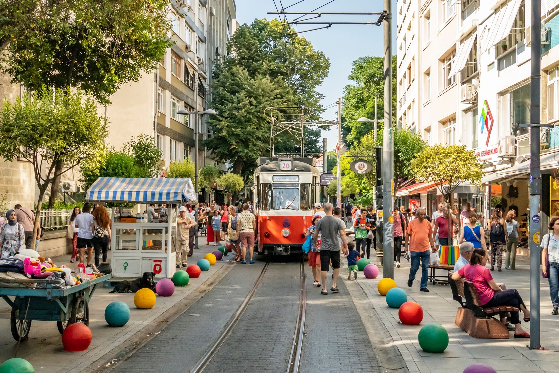 A Kadıköy street with the nostalgic tram and a mixed local crowd